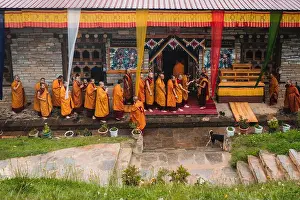 Bhutan Prints: Paro, Bhutan - 17 September 2025: View of saffron-robed monks gathered at Sangchekhor monastery