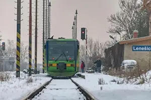 Passenger train with motor engine in winter snowy morning in cold village Lenesice CZ 12 09 2023