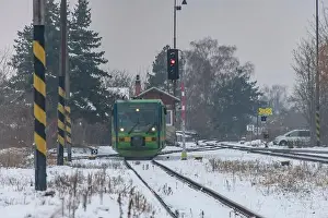 Turntable Prints: Passenger train with motor engine in winter snowy morning in cold village Lenesice CZ 12 09 2023