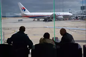 Malaysian Prints: Passengers awaiting departure at Melbourne International airport with a Malaysian Airlines Boeing 777 200