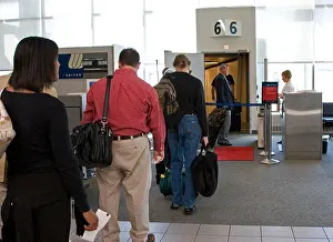 Leaving Prints: Passengers line up at airport gate to board plane