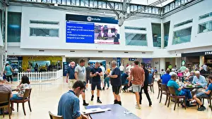 Disruption Prints: passengers looking up at departure board