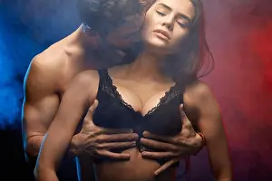 Girlfriend Prints: passionate man hugging his girlfriend breast and kissing her. close up photo