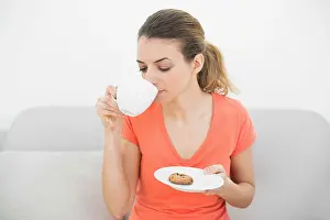 Homey Prints: Peaceful lovely woman drinking of cup sitting relaxing on couch