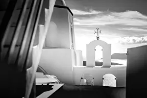 Peaceful view in Santorini, Greece with white architecture and flowers, cruise ships, Mediterranean summer mood, vacation and travel background