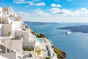 Peaceful view in Santorini, Greece with white architecture and flowers, cruise ships, Mediterranean summer mood, vacation and travel background