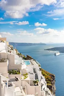 Peaceful view in Santorini, Greece with white architecture and flowers, cruise ships, Mediterranean summer mood, vacation and travel background