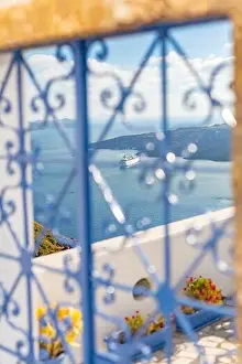 Peaceful view in Santorini, Greece with white architecture and flowers, cruise ships, Mediterranean summer mood, vacation and travel background