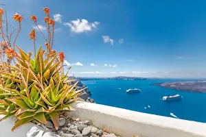 Peaceful view in Santorini, Greece with white architecture and pink flowers, cruise ships, Mediterranean summer mood, vacation and travel background