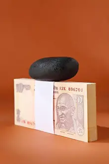 Reduction Prints: Pebble on bundle of ten rupee notes