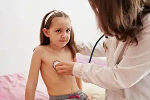Examine Prints: Pediatric doctor examine little happy girl with stethoscope