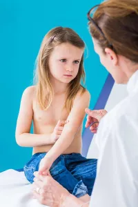 Skin Disease Prints: Pediatrician examining the skin of a 4 year old girl