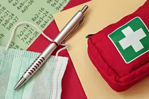 Stay Prints: Pen, medical mask and first aid kit on a school notebook