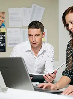 Whiteboard Prints: Two people at desk look at computer