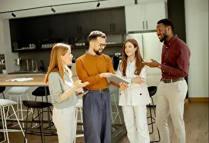 Networking Prints: Four people are discussing ideas in a bright office