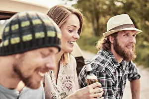 Getting Away From It All Prints: Three people holding bottled beer smiling