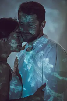 Projector Prints: two people in love hugging while standing on dark place