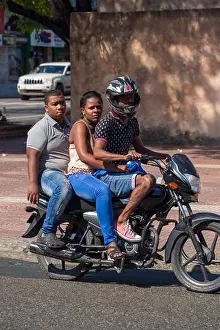 Dominican Republic Prints: Three people riding together on a motorcycle in Santo Domingo in the Dominican Republic
