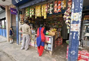 School Uniform Prints: People shopping in the Old Bazaar area of Pokhara, Nepal