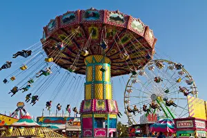 Thrill Prints: People spinning in air hanging in chairs on a carnival ride