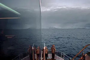Brim Prints: People watching the arctic ocean from the front of tour boat in northern Norway