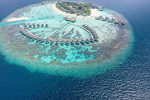 Perfect aerial landscape, luxury tropical resort or hotel with water villas and beautiful beach scenery. Amazing bird eyes view in Maldives, landscape