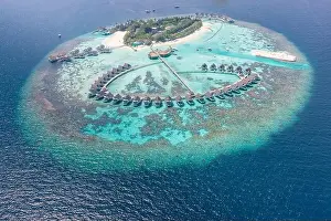 Perfect aerial landscape, luxury tropical resort or hotel with water villas and beautiful beach scenery. Amazing bird eyes view in Maldives, landscape