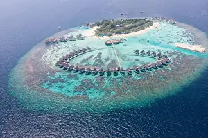 Perfect aerial landscape, luxury tropical resort or hotel with water villas and beautiful beach scenery. Amazing bird eyes view in Maldives, landscape