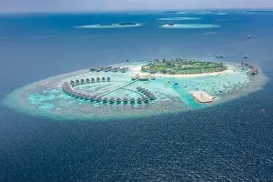 Perfect aerial landscape, luxury tropical resort or hotel with water villas and beautiful beach scenery. Amazing bird eyes view in Maldives, landscape