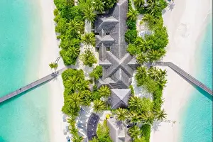 Perfect aerial landscape, luxury tropical resort or hotel with water villas and beautiful beach scenery. Amazing bird eyes view in Maldives, landscape