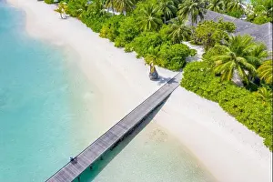 Perfect aerial landscape, luxury tropical resort or hotel with water villas and beautiful beach scenery. Amazing bird eyes view in Maldives, landscape