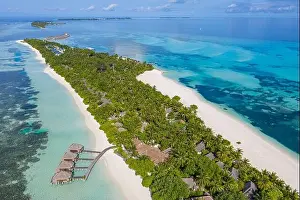 Perfect aerial scenic landscape, luxury tropical resort hotel with water villas and beautiful beach scenery. Amazing bird eyes view in Maldives reef