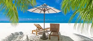 Perfect sunny beach. Idyllic tropical beach landscape for background. Couple honeymoon, romantic destination, freedom lounge chairs umbrella palm sand
