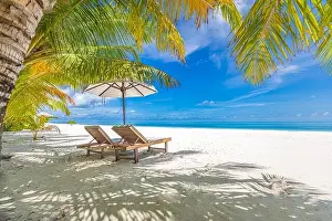 Perfect sunny beach. Idyllic tropical beach landscape for background. Couple honeymoon, romantic destination, freedom lounge chairs umbrella palm sand