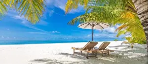 Perfect sunny beach. Idyllic tropical beach landscape for background. Couple honeymoon, romantic destination, freedom lounge chairs umbrella palm sand