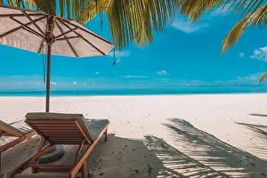 Perfect sunny beach. Idyllic tropical beach landscape for background. Couple honeymoon, romantic destination, freedom lounge chairs umbrella palm sand