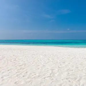 Perfect tranquil beach scene, soft sunlight and white sand and blue endless sea as tropical landscape. Sea sand sky concept. Summer travel vacation