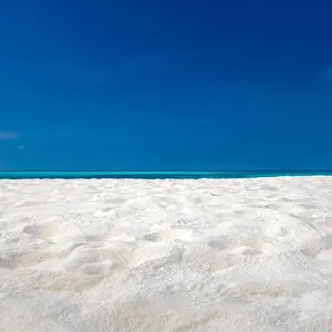 Perfect tranquil beach scene, soft sunlight and white sand and blue endless sea as tropical landscape. Sea sand sky concept. Summer travel vacation