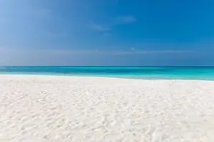 Perfect tranquil beach scene, soft sunlight and white sand and blue endless sea as tropical landscape. Sea sand sky concept. Summer travel vacation