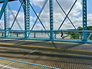 Water Sky Prints: Person jogging on Roebling Bridge in Cincinnati, OH with river view