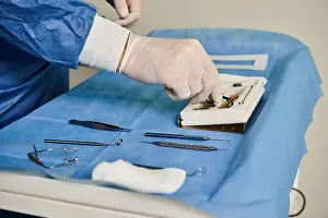 Medical Procedure Prints: A person lying in a hospital bed surrounded by surgical equipment