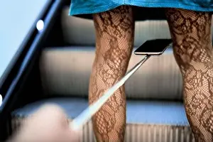 Person photographing under woman skirt upskirting upskirt sextortion law