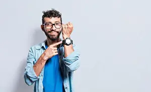 Face To Face Prints: Person pointing at his watch looking at the camera
