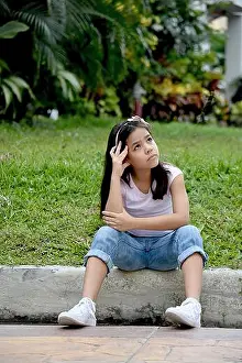 Deciding Prints: Petite Asian Girl Making A Decision