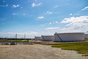 Room For Copy Prints: petrochemical holding tanks at tank farm in Cushing Oklahoma USA with pond