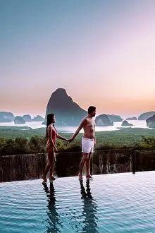 Infinity Prints: Phangnga Bay Thailand, couple on the edge of an swimming pool watching sunrise Thailand infinity pool