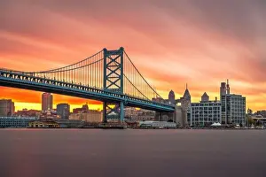 Philadelphia, Pennsylvania, USA skyline on the Delaware river with Ben Franklin Bridge at dusk