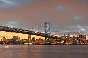 Philadelphia, Pennsylvania, USA skyline on the Delaware river with Ben Franklin Bridge at night