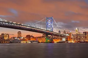 Philadelphia, Pennsylvania, USA skyline on the Delaware river with Ben Franklin Bridge at night