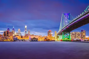 Philadelphia, Pennsylvania, USA skyline on the Delaware river with Ben Franklin Bridge at night